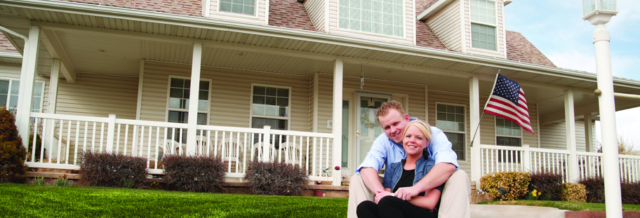 Photo of family outside of house